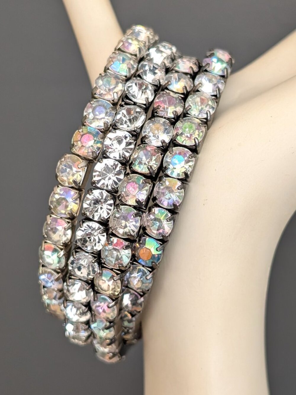 Bundle of 4 metal stretch bracelets with clear and aurora borealis beads